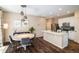 Eat-in kitchen area featuring an island with stone countertop, stainless steel appliances, and modern lighting at 11033 E 28Th Pl, Denver, CO 80238