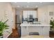 Bright kitchen featuring white cabinets, stainless steel appliances, and a kitchen island with marble countertop at 11033 E 28Th Pl, Denver, CO 80238