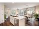 Kitchen with island overlooking living and dining areas, providing an open and inviting layout at 11033 E 28Th Pl, Denver, CO 80238