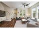 Bright living room with hardwood floors, neutral decor, and large windows offering natural light at 11033 E 28Th Pl, Denver, CO 80238