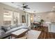 Spacious living room that flows into the dining area with modern furnishings and plenty of natural light at 11033 E 28Th Pl, Denver, CO 80238