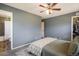 Spacious bedroom with ceiling fan, adjacent bathroom, and walk-in closet at 11033 E 28Th Pl, Denver, CO 80238