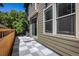 Back patio boasts a sliding door, tiled floor, fence perimeter, and tree coverage at 11033 E 28Th Pl, Denver, CO 80238