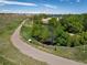 Scenic walking path winding along a pond with a wooden fence, surrounded by lush greenery at 11033 E 28Th Pl, Denver, CO 80238