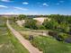 Picturesque walking path next to a pond surrounded by lush greenery and clear blue skies at 11033 E 28Th Pl, Denver, CO 80238