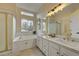 Elegant bathroom with double vanity, soaking tub, and shower at 2903 S Walden Way, Aurora, CO 80013