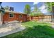 Inviting backyard featuring a patio, outdoor seating, green grass, and a privacy fence for secluded relaxation at 3090 S High St, Denver, CO 80210