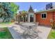 Secluded backyard with brick exterior, a patio, and outdoor seating for dining al fresco at 3090 S High St, Denver, CO 80210