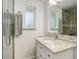 Updated bathroom with a sleek vanity, stone countertop, glass shower, and modern finishes at 3090 S High St, Denver, CO 80210