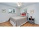 Cozy bedroom with a wrought iron bed frame, hardwood floors, and bright natural light at 3090 S High St, Denver, CO 80210