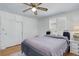 Comfortable bedroom with ceiling fan, plantation shutters, and neutral decor at 3090 S High St, Denver, CO 80210