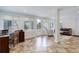 Bright and spacious bonus room with tile flooring, multiple windows, and an access door to the yard at 3090 S High St, Denver, CO 80210