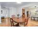 Cozy dining area adjacent to the kitchen featuring a round table and hardwood floors at 3090 S High St, Denver, CO 80210