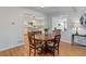 Cozy dining area adjacent to the kitchen featuring a round table and hardwood floors at 3090 S High St, Denver, CO 80210