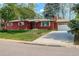 Charming brick ranch-style home with a well-manicured lawn and a two-car attached garage at 3090 S High St, Denver, CO 80210