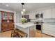 Bright kitchen with stainless steel appliances, granite countertops, and center island with seating at 3090 S High St, Denver, CO 80210