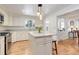 Bright kitchen with stainless steel appliances, granite countertops, and center island with seating at 3090 S High St, Denver, CO 80210