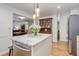 Bright kitchen with stainless steel appliances, granite countertops, and center island with seating at 3090 S High St, Denver, CO 80210