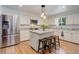 Bright kitchen with stainless steel appliances, granite countertops, and center island with seating at 3090 S High St, Denver, CO 80210