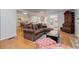 Open-concept living room with hardwood floors and a seamless flow to the kitchen at 3090 S High St, Denver, CO 80210