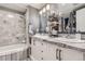 Elegant bathroom featuring a dual sink vanity with marble countertops and a bathtub shower at 800 N Pearl St # 206, Denver, CO 80203
