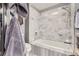 Bathroom with gray marble tiles, bath and shower with a marble trim at 800 N Pearl St # 206, Denver, CO 80203