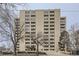 Governor's Place high rise apartment building exterior with bare trees, parking entrance, and building signage at 800 N Pearl St # 206, Denver, CO 80203