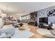 Spacious living room with a fireplace and hardwood floors leading into an open kitchen layout at 800 N Pearl St # 206, Denver, CO 80203