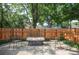 Backyard patio area with seating and wooden fence at 1695 E Eastman Ave, Englewood, CO 80113