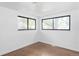 Empty bedroom with hardwood floors and two windows at 1695 E Eastman Ave, Englewood, CO 80113