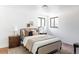 Bright bedroom with neutral tones, two windows, and hardwood floors at 1695 E Eastman Ave, Englewood, CO 80113