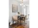 Eat-in kitchen with round table and modern chandelier, next to sliding glass door at 1695 E Eastman Ave, Englewood, CO 80113