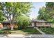 Charming brick ranch-style home with mature trees, a landscaped front yard, and a welcoming entrance at 1695 E Eastman Ave, Englewood, CO 80113