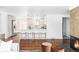 Modern kitchen with white cabinets, stainless steel appliances, and a breakfast bar with stylish seating at 1695 E Eastman Ave, Englewood, CO 80113
