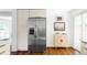 Bright kitchen featuring stainless steel refrigerator and natural wood floors at 1695 E Eastman Ave, Englewood, CO 80113