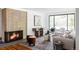 Stylish living room featuring a brick fireplace, contemporary furniture, and abundant natural light at 1695 E Eastman Ave, Englewood, CO 80113
