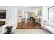 Open concept living space with hardwood floors, connected to kitchen and dining area at 1695 E Eastman Ave, Englewood, CO 80113