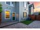 A backyard features gray siding, a fenced yard, and a stone patio with a synthetic grass area at 8421 E 29Th Ave, Denver, CO 80238
