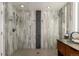 Luxurious bathroom features a large, tiled shower with dual shower heads and glass enclosure at 8421 E 29Th Ave, Denver, CO 80238