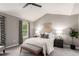 Well-lit bedroom with carpet flooring, ceiling fan, and decoratively patterned curtains at 8421 E 29Th Ave, Denver, CO 80238