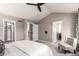 Bedroom with a view of the closet and bathroom, features carpet flooring and a ceiling fan at 8421 E 29Th Ave, Denver, CO 80238