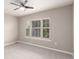 Neutral bedroom with plush carpet, ceiling fan, and wide windows bringing in lots of natural light at 8421 E 29Th Ave, Denver, CO 80238