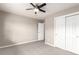 Neutral bedroom features carpet, ceiling fan, and closet with mirrored sliding doors at 8421 E 29Th Ave, Denver, CO 80238