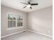 Neutral bedroom with carpet, a ceiling fan, and large windows offering natural light at 8421 E 29Th Ave, Denver, CO 80238
