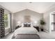 Bedroom with a sloped ceiling, carpet flooring, ceiling fan and decoratively patterned curtains at 8421 E 29Th Ave, Denver, CO 80238