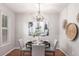 Elegant dining room with chandelier and modern artwork, perfect for entertaining at 8421 E 29Th Ave, Denver, CO 80238
