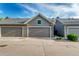 Contemporary townhome showcasing a well-kept lawn and convenient two-car garage at 8421 E 29Th Ave, Denver, CO 80238