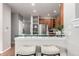 Kitchen with stainless steel refrigerator, wooden cabinets, white countertops, and bar seating at 8421 E 29Th Ave, Denver, CO 80238