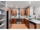 Spacious kitchen featuring wooden cabinets, stainless steel appliances, and hardwood floors at 8421 E 29Th Ave, Denver, CO 80238