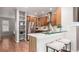 Open kitchen with stainless steel refrigerator, white countertops and a breakfast bar with seating at 8421 E 29Th Ave, Denver, CO 80238